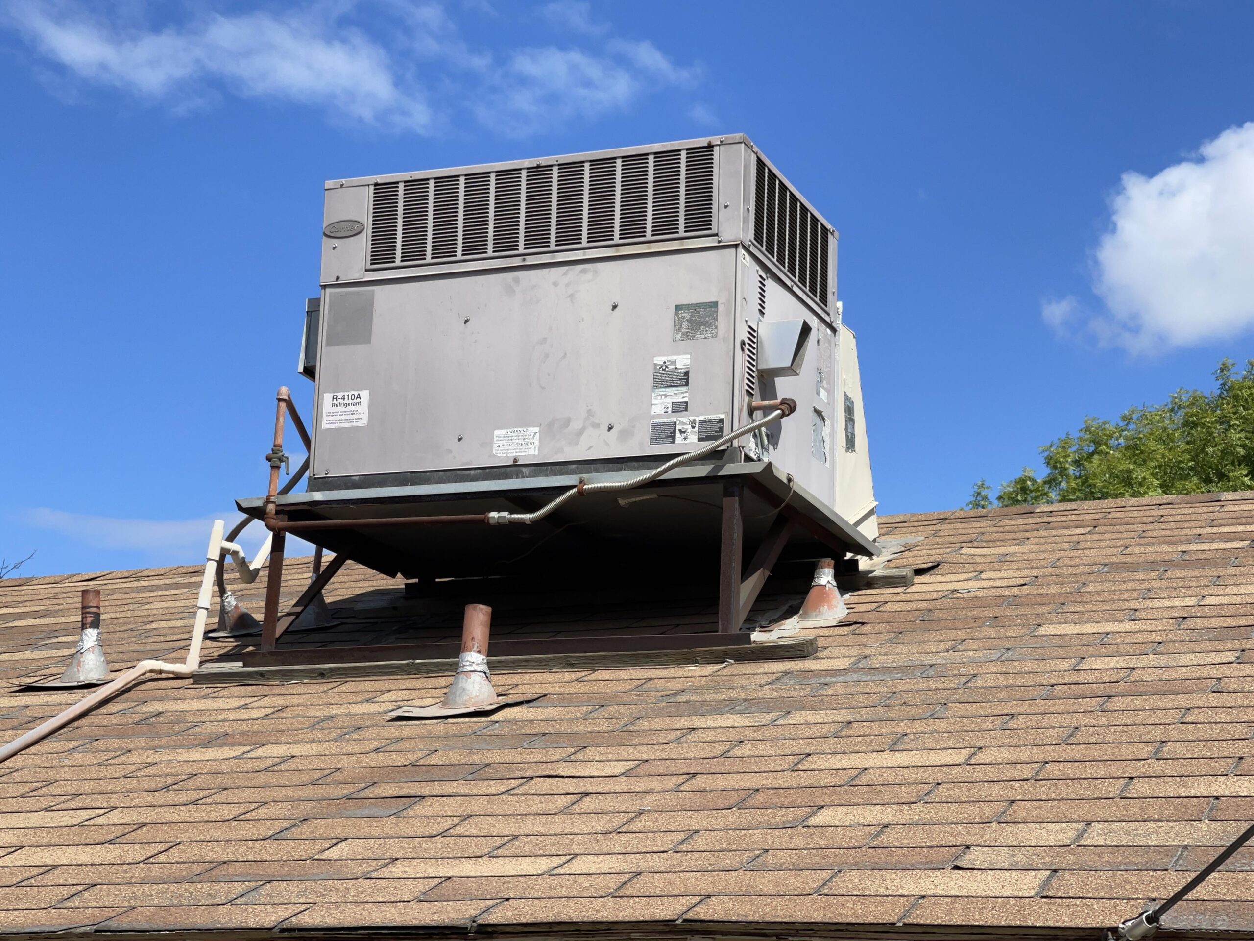 HVAC unit on rooftop protected by pigeon nest removal to avoid damage from nesting birds